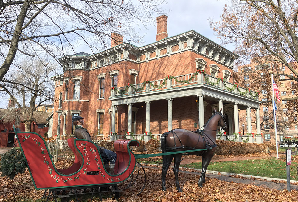 outdoor photograph of the mansion during late december, circa 2018. Photograph shows a sleigh being pulled by a horse in front of the mansion.