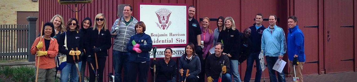Photograph of volunteers at the Presidential Site for Indy Do Day. There are sixteen people posing for a photo outside of the welcome center.