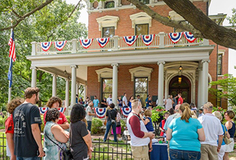 Crowd gathered outside the Presidential Site on a sunny day in July.