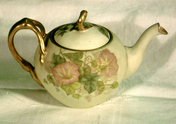 Three piece set plus companion Orchid tray. Tea pot, sugar, and creamer all hand-painted with morning glories by Mrs. Caroline Scott Harrison in pastel tones, green leaves and gold trim. Tea pot and sugar bowl have lids and gold twig like handles. The Orchid tray is done in matching tones and style.