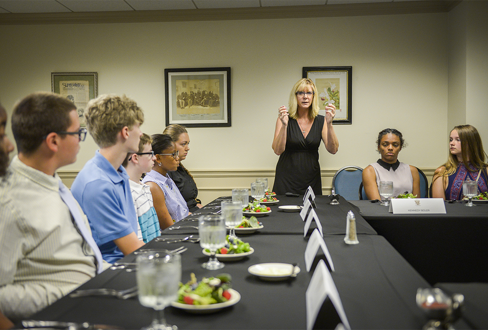 Photograph of students participating in an etiquette class.